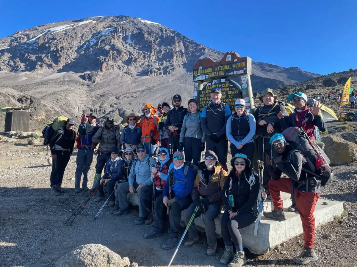 Climbers trekking the 8-day Lemosho Route with Kilimanjaro summit, scenic Shira Plateau, Barranco Wall, mountain tents, and alpine landscapes